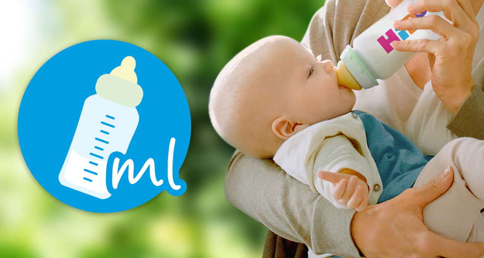 A baby is being fed from a bottle.